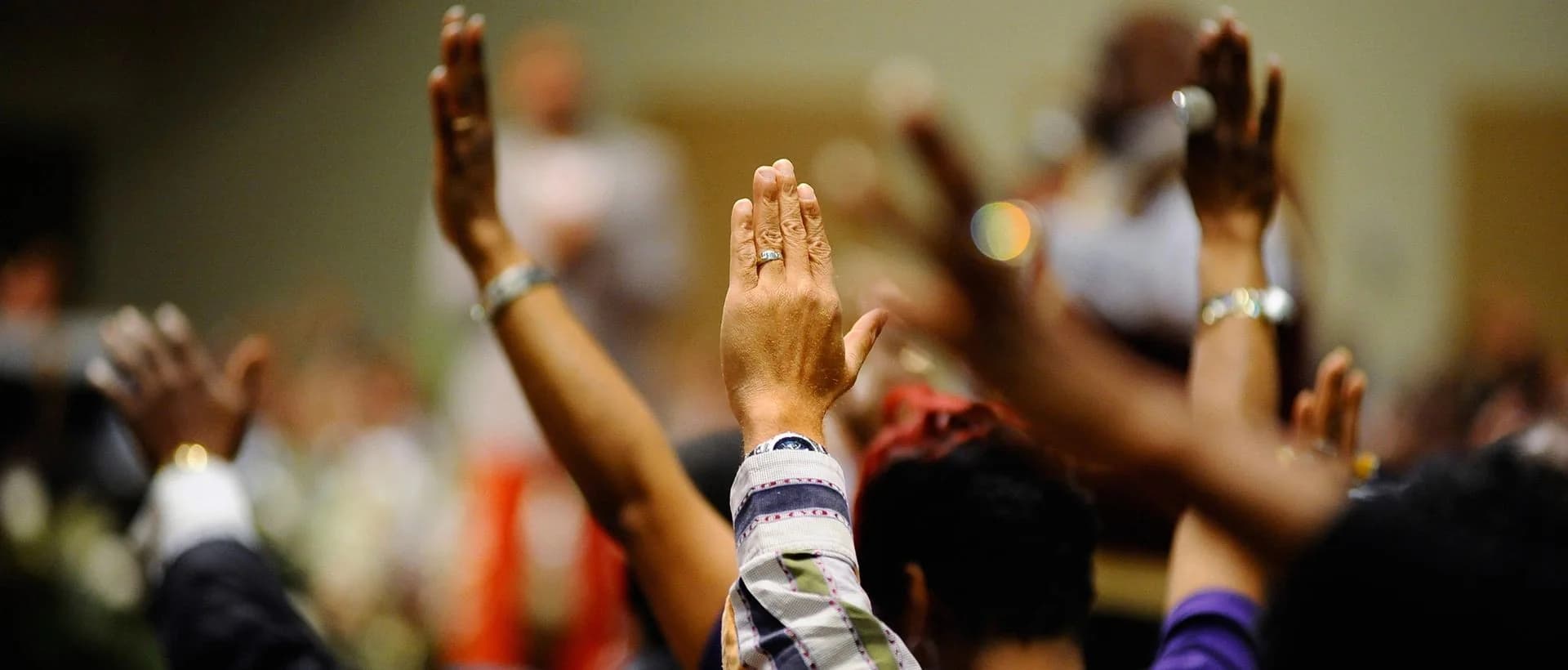People worshiping with raised hands
